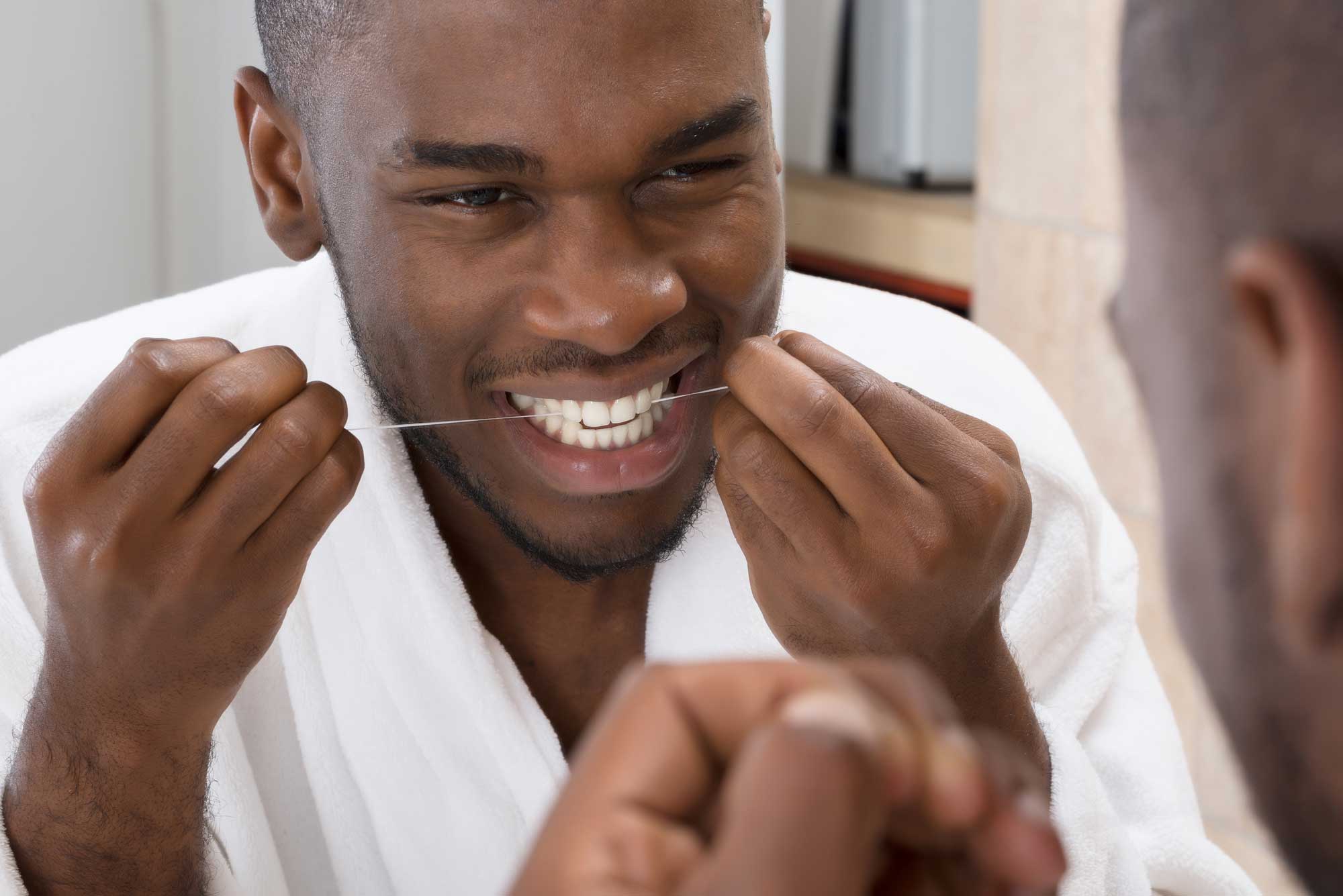 person flossing teeth