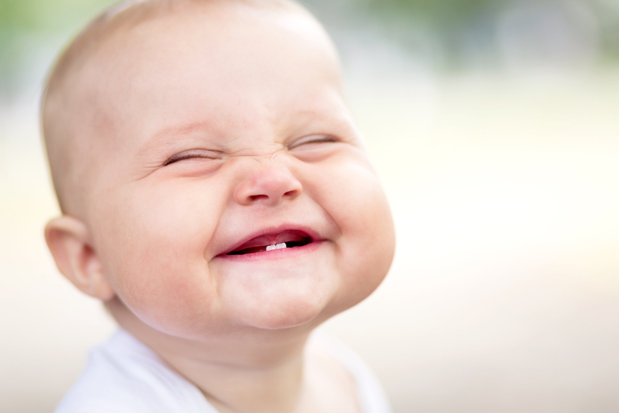 smiling baby with two baby teeth