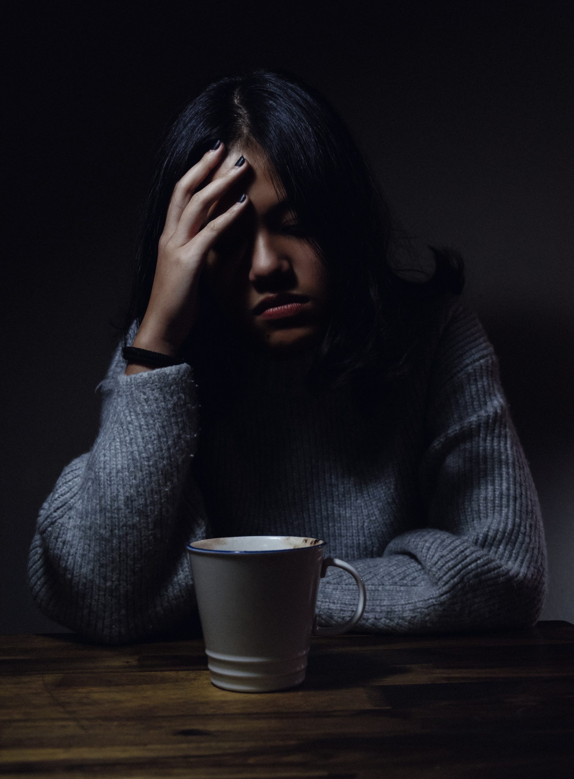 woman holding head from headache due to teeth grinding