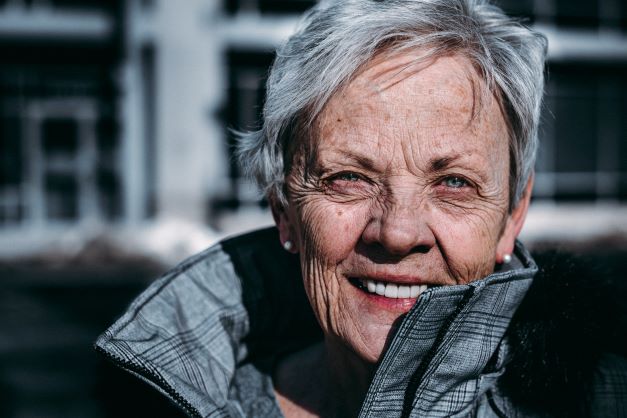 older woman smiling with dental implants