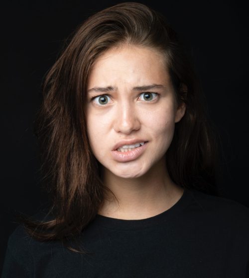 Girl looks concerned after addressing teeth grinding in New South Wales