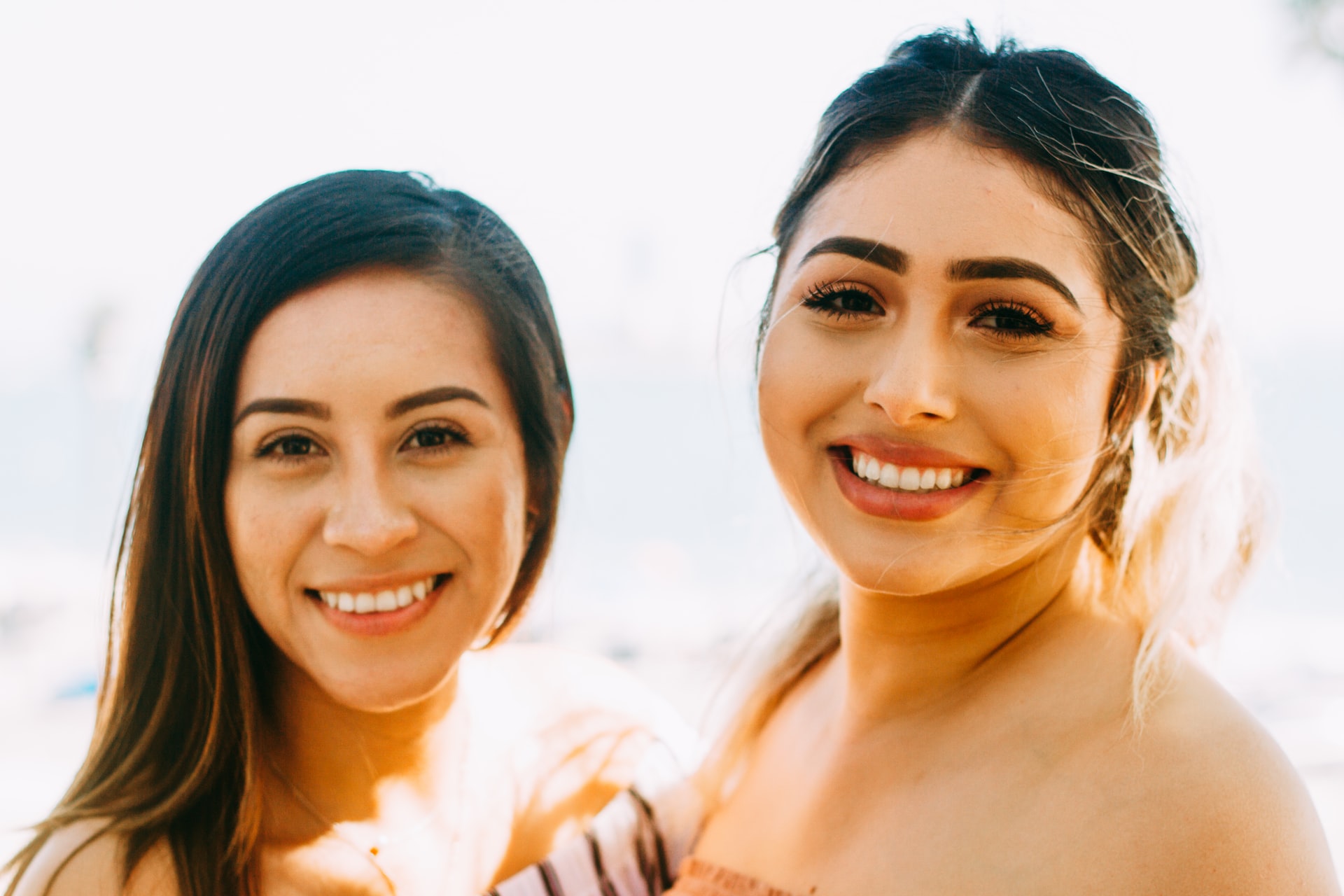 two girls smiling-cost of dental bridges