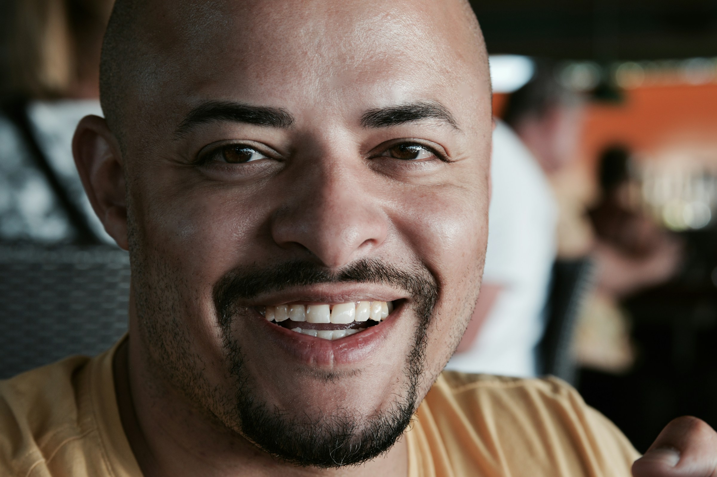 Smiling man with goatee and shaved head