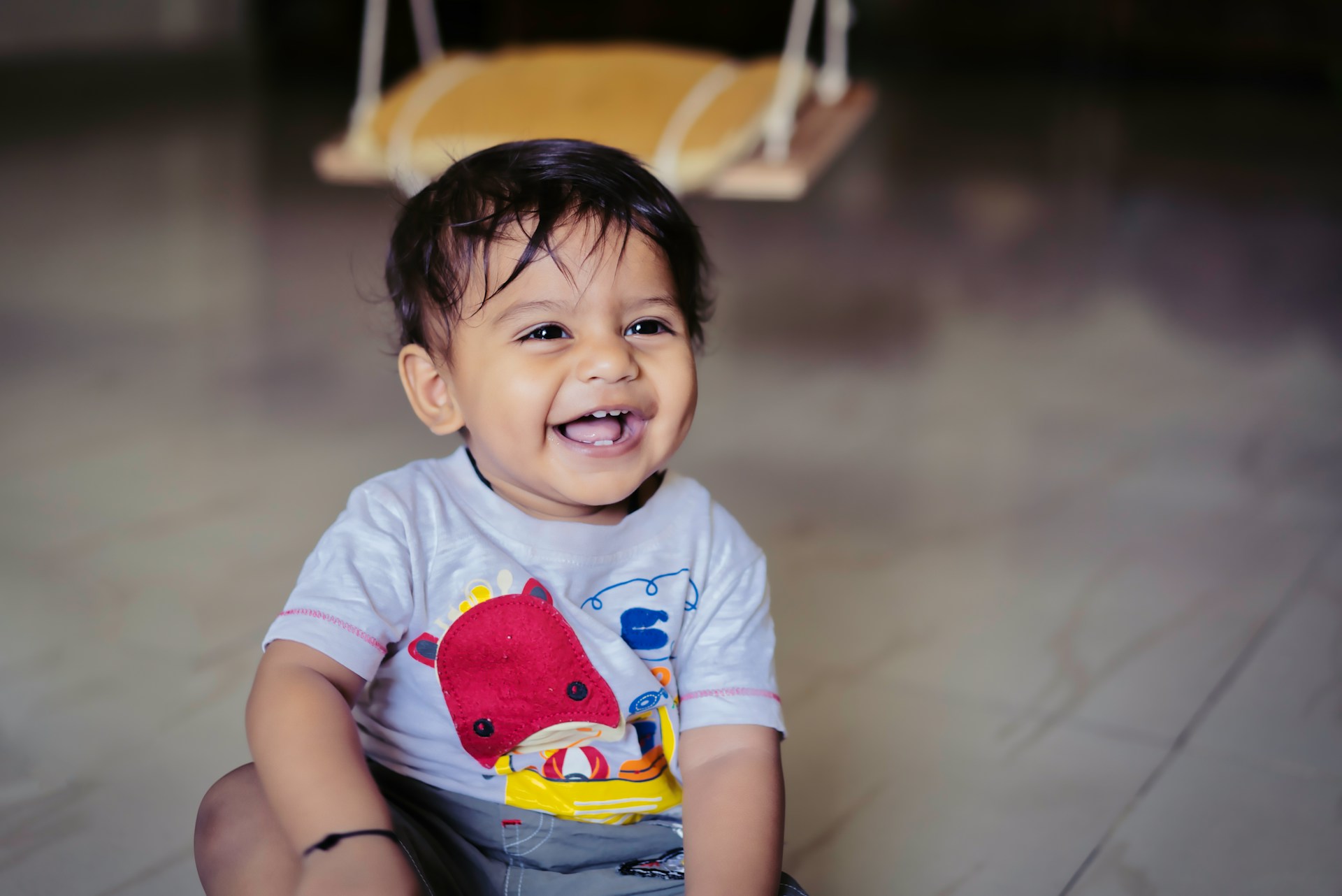 happy little boy sitting on the floor