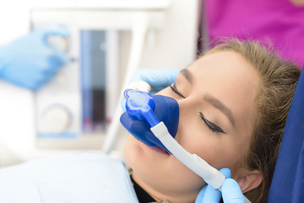 woman getting sleep dentistry services at dentist office